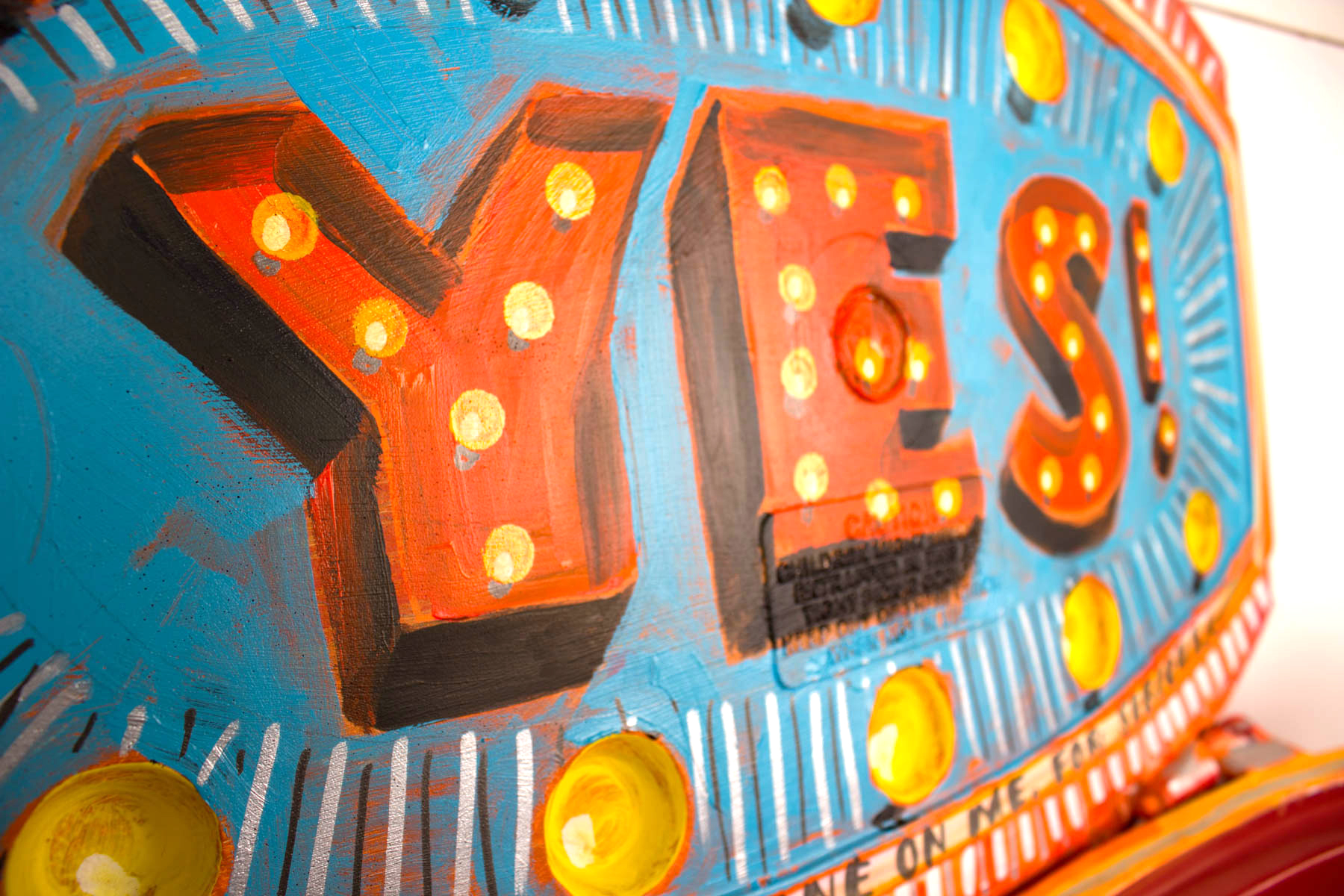 A close up of the word yes on a carnival ride.